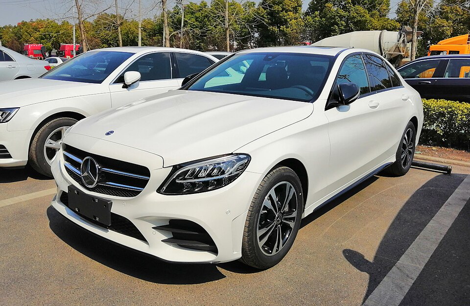 White Mercedes-Benz luxury sedan available for wedding and barat booking — QuickAura Travels